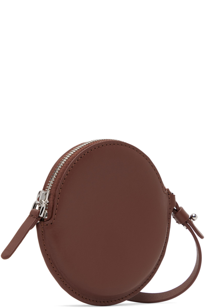 Buffed calfskin pouch in brown. 

· Detachable and adjustable wristlet strap
· Zip closure 
· Twill lining 
· H4.25 x W4.5 x D0.25 in 

Part of the ECCO.kollektive x Isaac Reina collaboration. 

Supplier color: Chestnut