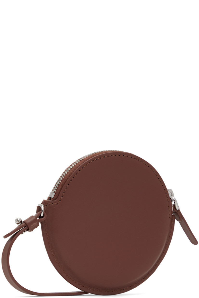 Buffed calfskin pouch in brown. 

· Detachable and adjustable wristlet strap
· Zip closure 
· Twill lining 
· H4.25 x W4.5 x D0.25 in 

Part of the ECCO.kollektive x Isaac Reina collaboration. 

Supplier color: Chestnut