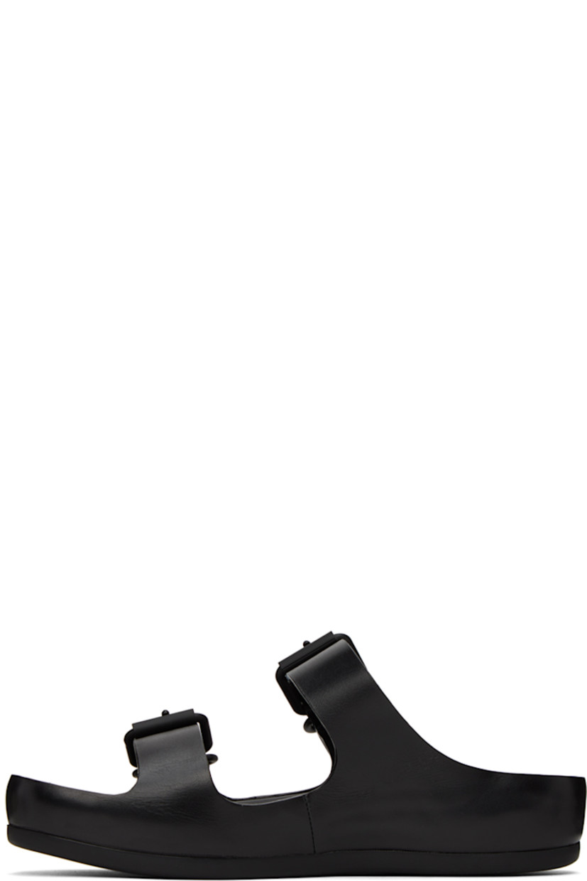 Grained calfskin flat sandals in black. 

· Open round toe
· Adjustable pin-buckle straps at vamp
· Logo embossed at leather footbed
· Covered leather platform midsole
· Treaded rubber outsole
· Platform: H1.5 in 

Part of the ECCO.kollektive x Natacha Ramsay Levi collaboration. 

Supplier color: Black