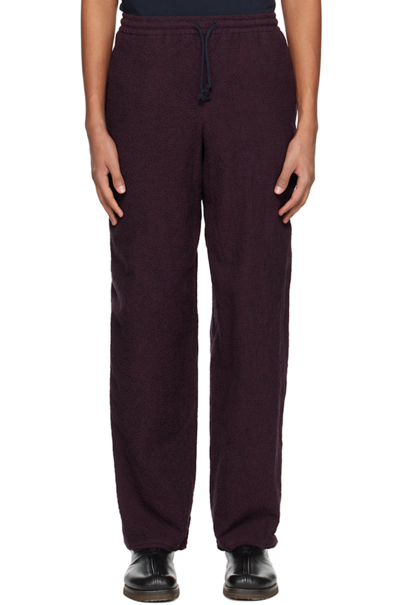 Cotton and wool-blend seersucker trousers.

· Drawstring at elasticized waistband
· Two-pocket styling
· Raw edge at cuffs

Supplier color: Burgundy