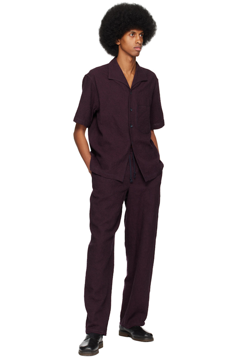 Cotton and wool-blend seersucker trousers.

· Drawstring at elasticized waistband
· Two-pocket styling
· Raw edge at cuffs

Supplier color: Burgundy