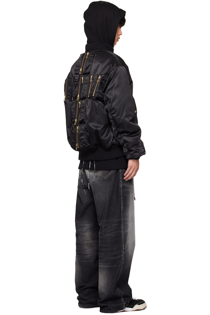 Padded nylon satin bomber jacket. Zip pockets and utility pockets throughout.

· Rib knit stand collar, hem, and cuffs
· Zip closure
· Flap pockets
· Welt pockets at interior
· D-ring at interior
· Detachable logo-woven strap at interior
· Logo-engraved silver-tone and gold-tone hardware

Part of the Mastermind World x Phenomenon collaboration.

Supplier color: Black