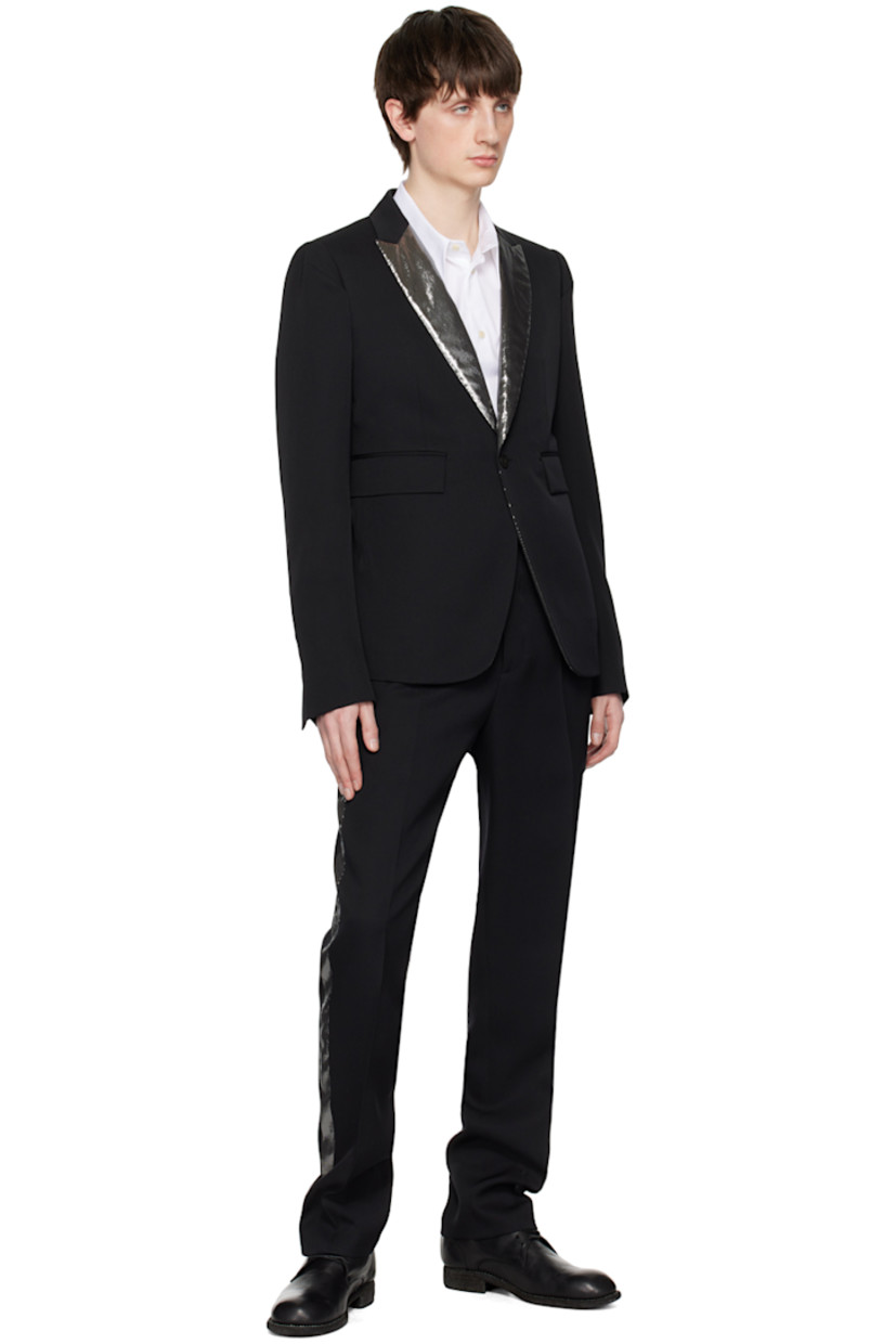 Wool gabardine blazer. 

· Metallic thread detailing at notched lapel
· Single-button closure
· Flap pockets
· Darts at front and back
· Padded shoulders
· Four-button surgeon's cuffs
· Central vent at back hem
· Welt pockets at interior
· Partial satin lining
· Horn hardware

Supplier color: Black/Silver