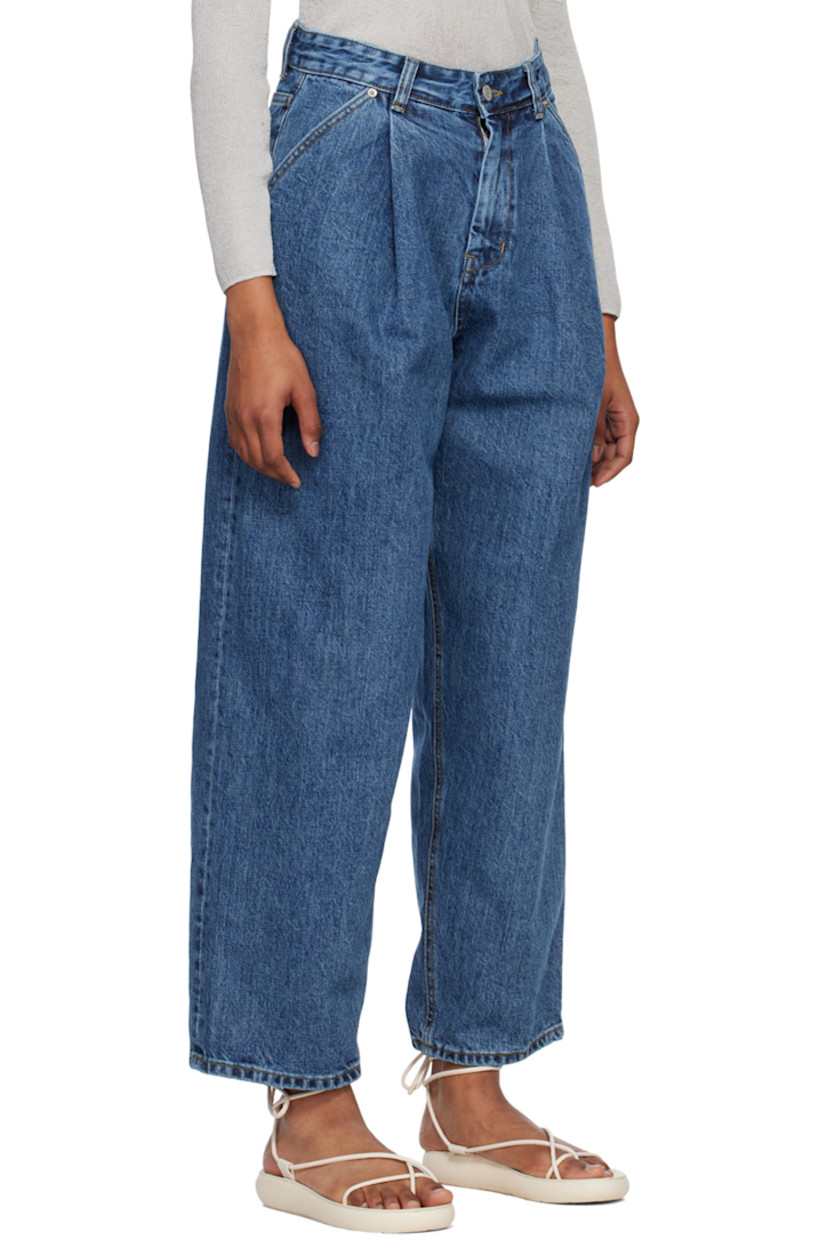 Wide-leg 14 oz non-stretch organic cotton Okayama denim jeans. 

· Belt loops
· Zip-fly
· Four-pocket styling
· Pleated front
· Leather logo patch at back waistband
· Contrast stitching in tan

Supplier color: Medium blue