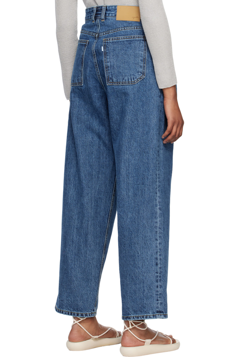 Wide-leg 14 oz non-stretch organic cotton Okayama denim jeans. 

· Belt loops
· Zip-fly
· Four-pocket styling
· Pleated front
· Leather logo patch at back waistband
· Contrast stitching in tan

Supplier color: Medium blue
