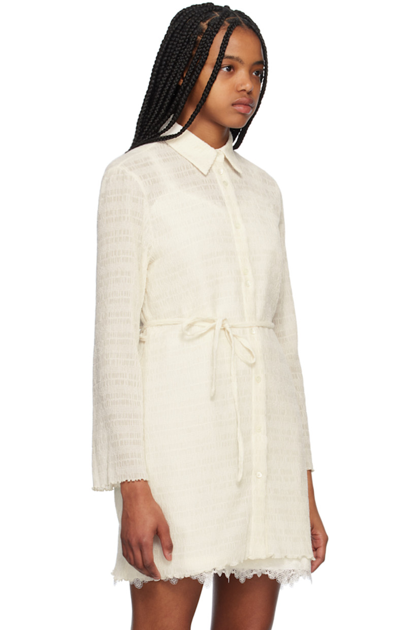 Semi-sheer stretch polyester mesh shirt. Shirring throughout. 

· Spread collar 
· Button closure 
· Belt loops and detachable self-tie belt

Supplier color: Ivory