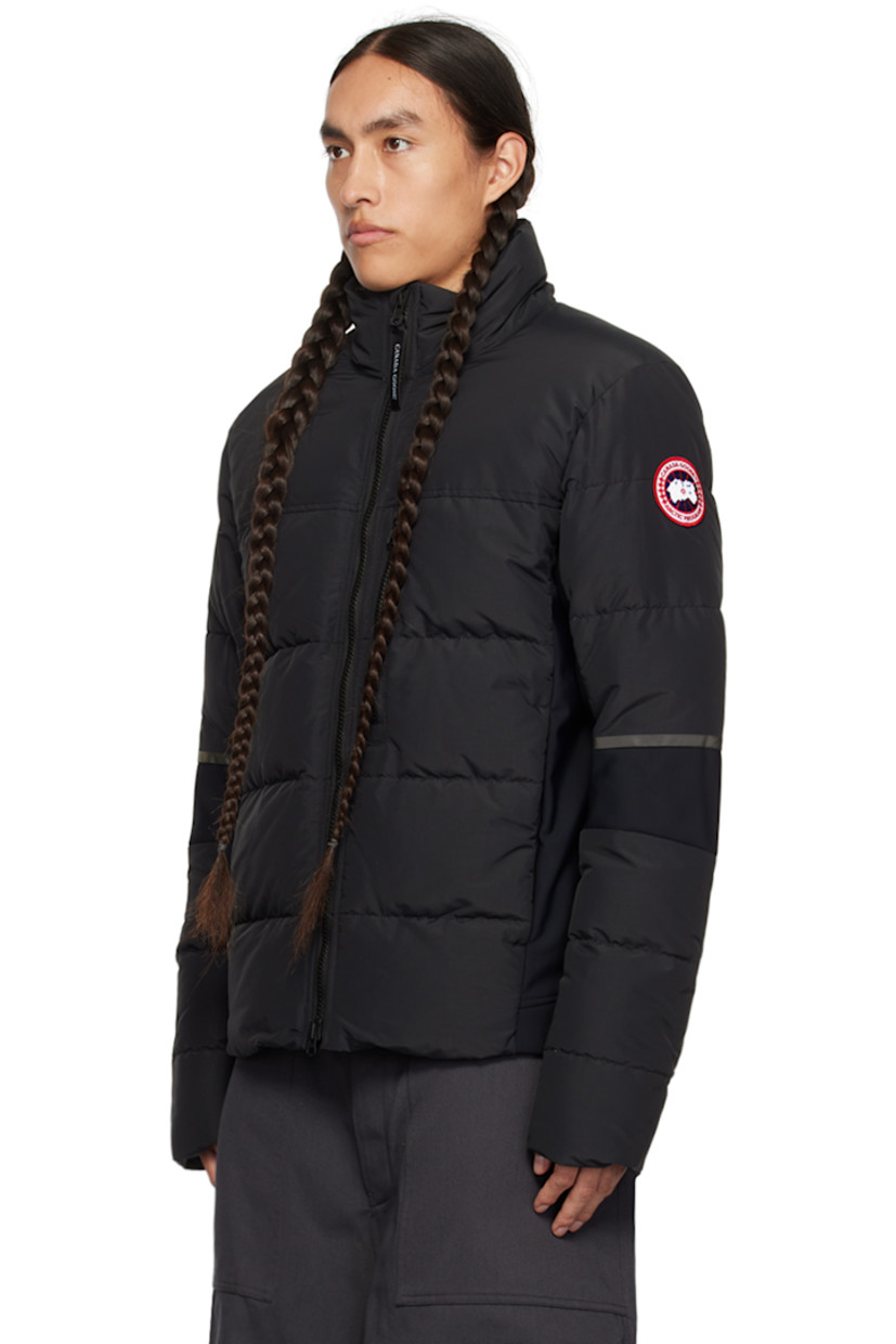 Down-filled quilted water-repellent CORDURA® nylon faille and stretch nylon jersey jacket. Reflective trim throughout.

· Paneled construction 
· Stand collar
· Two-way zip closure
· Zip pockets
· Logo patch at sleeve
· Inset Power Stretch® jersey cuffs
· Elasticized straps and patch pocket at interior
· Full laqué lining

Supplier color: Black

Fill: 90% duck down, 10% duck feather.