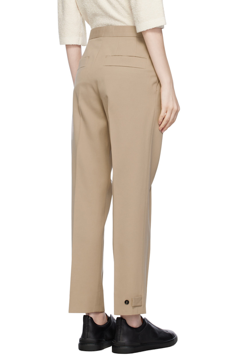 Cotton- and wool-blend twill trousers. 

· High-rise
· Integrated cinch belt at waistband 
· Four-pocket styling
· Zip-fly
· Pleats at front waistband
· Central creases at front 
· Adjustable button tabs at cuffs 
· Partial cotton twill lining 

Supplier color: Beige