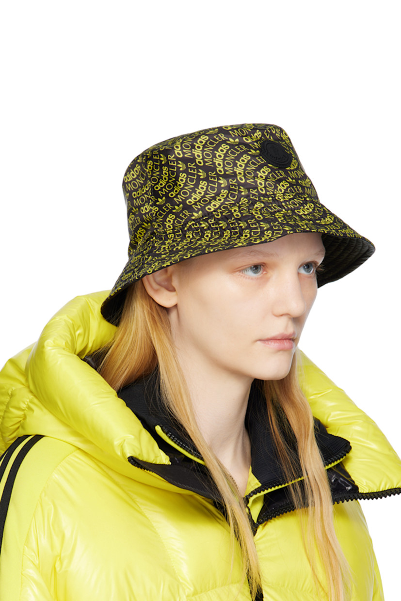 Reversible polyester satin bucket hat in black. Logo pattern printed in yellow throughout.

Reverse in black nylon satin.

· Quilted brim
· Rubberized logo patch at interior

Part of the 3 Moncler adidas Originals collection.

Supplier color: Yellow