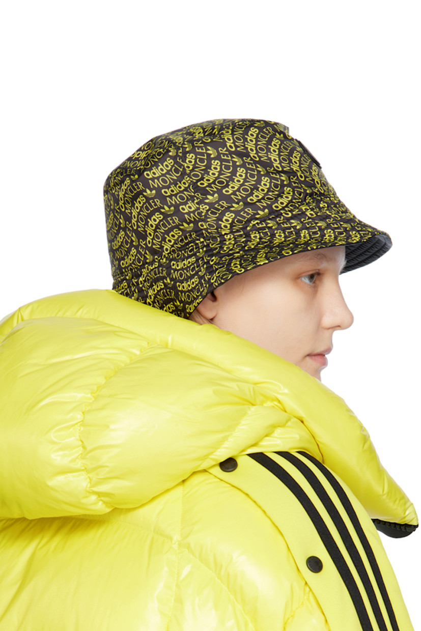 Reversible polyester satin bucket hat in black. Logo pattern printed in yellow throughout.

Reverse in black nylon satin.

· Quilted brim
· Rubberized logo patch at interior

Part of the 3 Moncler adidas Originals collection.

Supplier color: Yellow