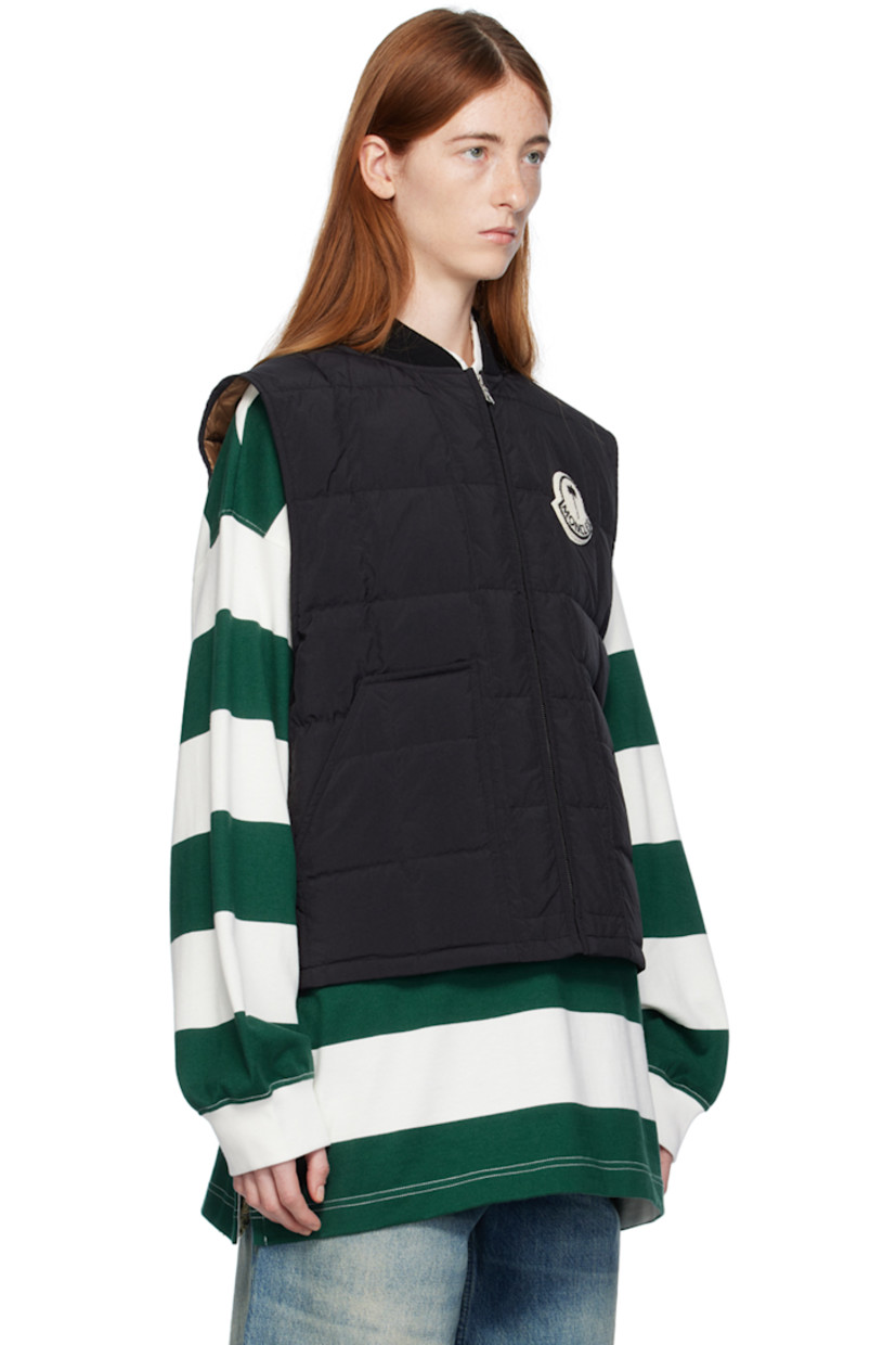 Down-filled quilted nylon taffeta vest. 

· Rib knit stand collar 
· Zip closure 
· Chenille logo patch at chest 
· Patch pockets 
· Shirttail hem 
· Full satin lining 

Part of the Moncler Genius x Palm Angels collaboration.

Supplier color: Black 

Fill: 90% goose down, 10% feathers.