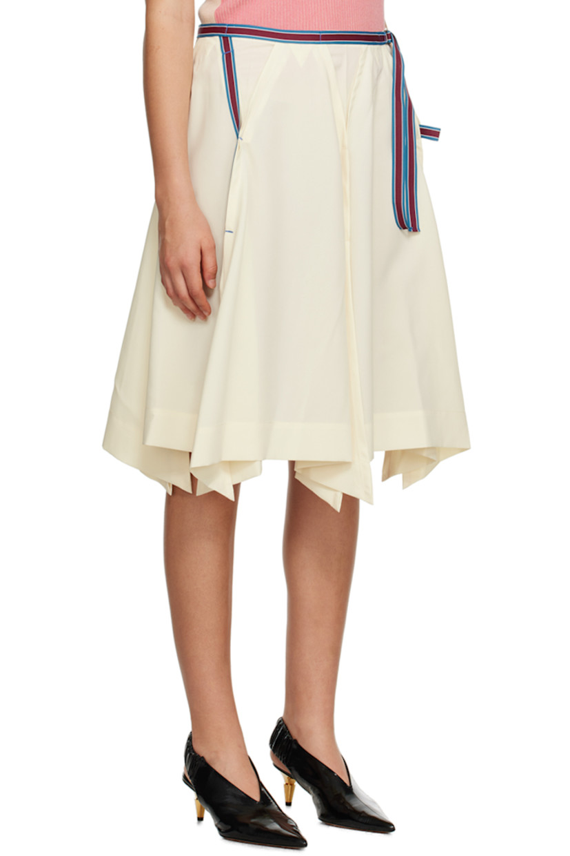 Recycled polyester broadcloth skirt. Striped grosgrain trim and pleats throughout.

· Paneled construction
· Integrated cinch strap at waist
· Inverted box pleats at front and back
· Vents at handkerchief hem
· Button closure at side seam

Supplier color: Off white