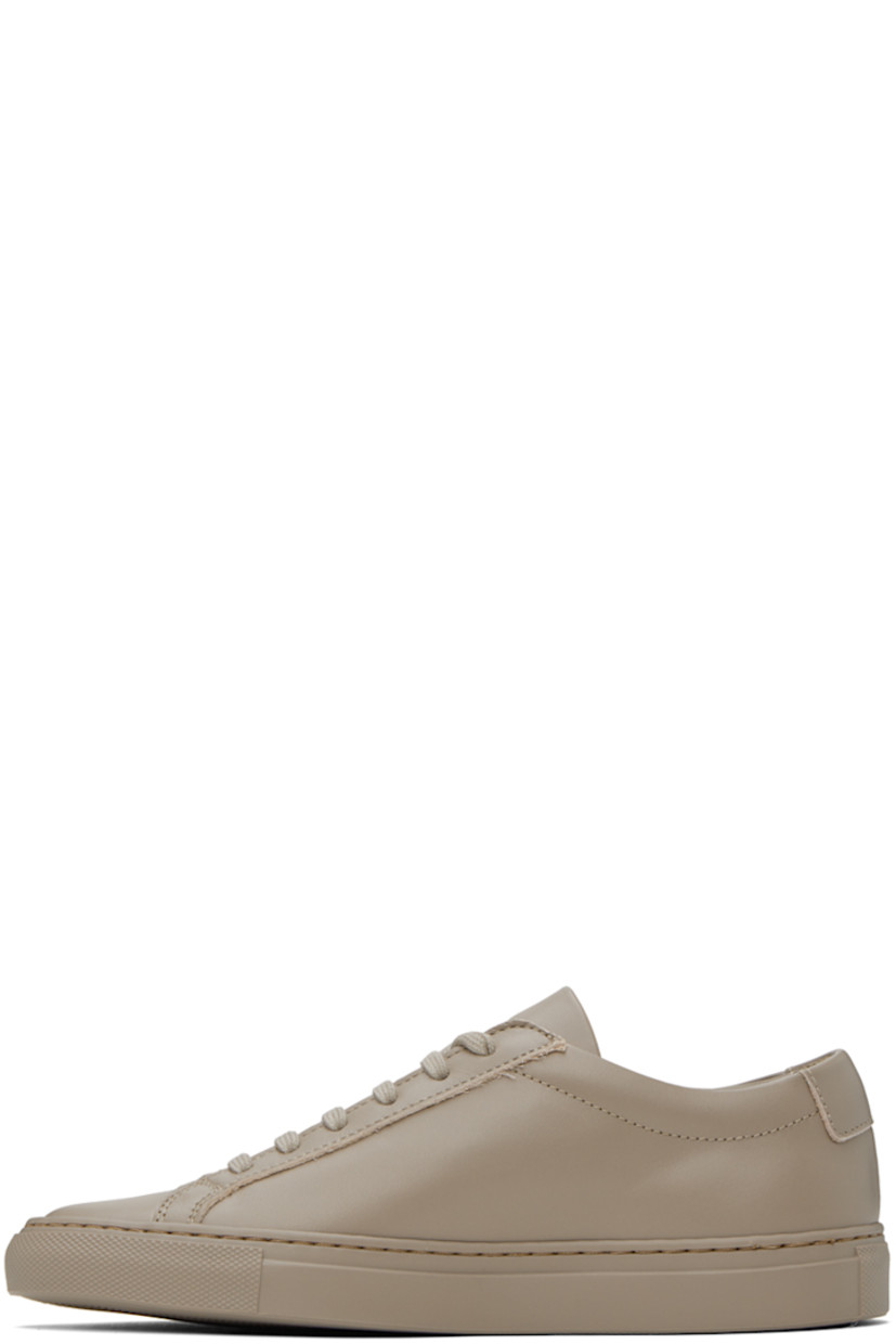 Low-top buffed leather sneakers in taupe. Signature series stamp in gold-tone at outer side.

· Lace-up closure
· Padded tongue and collar
· Partial suede and buffed leather lining
· Treaded rubber sole

Supplier color: Taupe