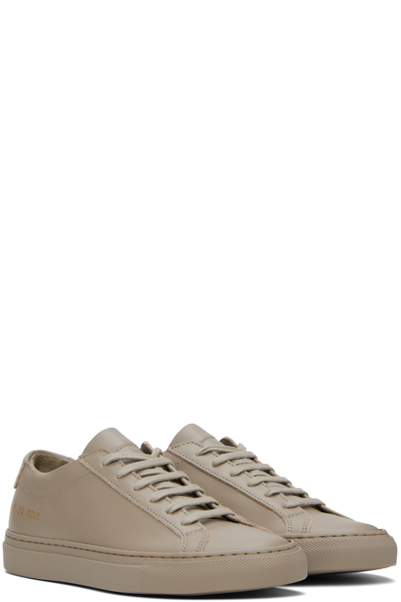 Low-top buffed leather sneakers in taupe. Signature series stamp in gold-tone at outer side.

· Lace-up closure
· Padded tongue and collar
· Partial suede and buffed leather lining
· Treaded rubber sole

Supplier color: Taupe