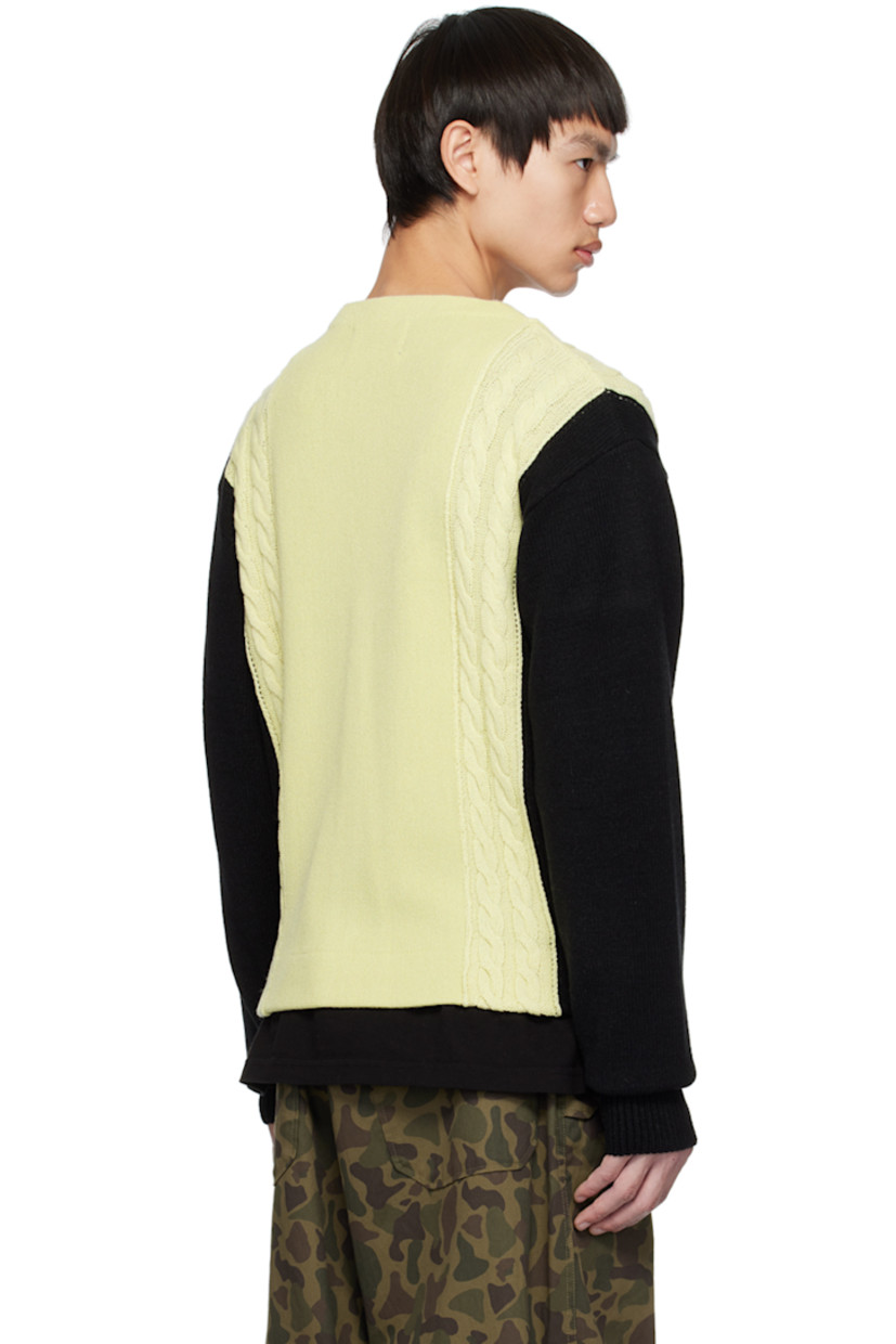 Cable knit wool- and acrylic-blend cardigan.

· Colorblocked consturction
· Rib knit Y-neck, hem, and cuffs
· Button closure
· Logo flag at side seam

Supplier color: Ivory/Black