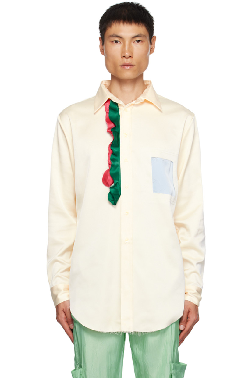 Polyester satin shirt.

· Spread collar
· Button closure
· Ruffled trim and patch at front
· Raw edge at shirttail hem
· Single-button barrel cuffs

Supplier color: Cream/Multi
