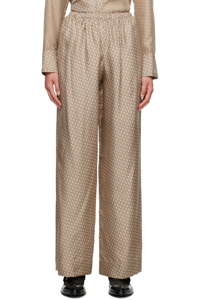 Silk twill lounge pants. 

· Graphic pattern throughout
· Elasticized waistband

Supplier color: Crema linka print