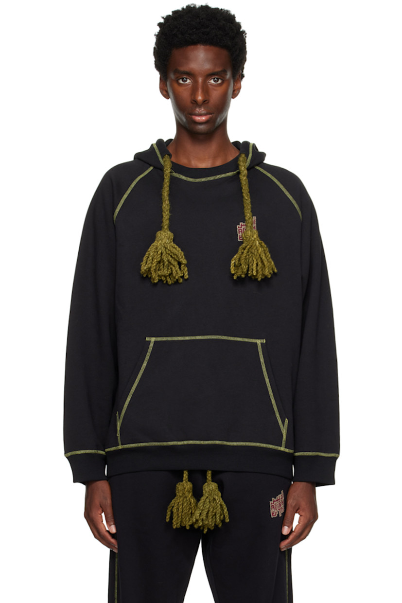 Cotton-blend fleece hoodie. 

�· Hand-woven awassi wool Bedouin tassels at hood
· Hand-stitched tatreez embroidery at chest
· Kangaroo pocket
· Rib knit hem and cuffs
· Raglan sleeves
· Contrast stitching in green

Supplier color: Black