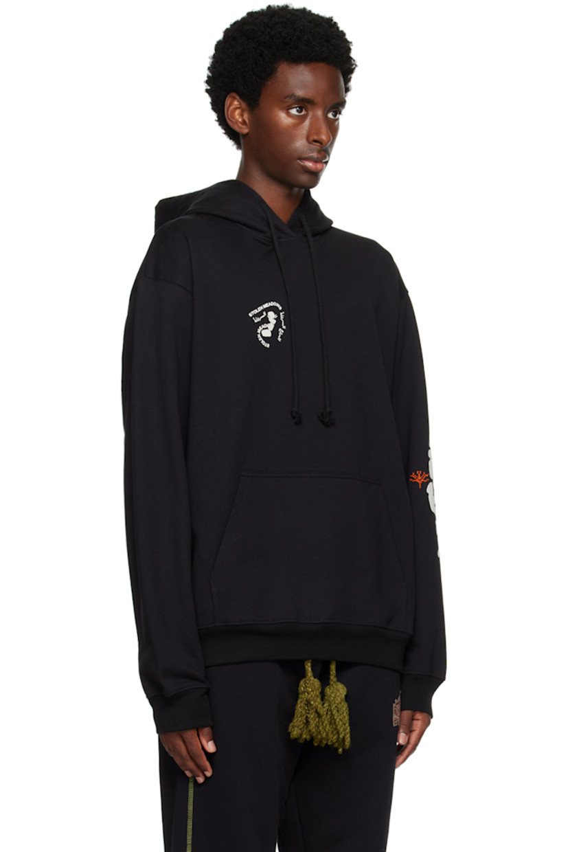 French terry hoodie. Hand-stitched tatreez embroidery and printed graphics throughout. 

· Drawstring at hood
· Kangaroo pocket
· Rib knit hem and cuffs

Supplier color: Black