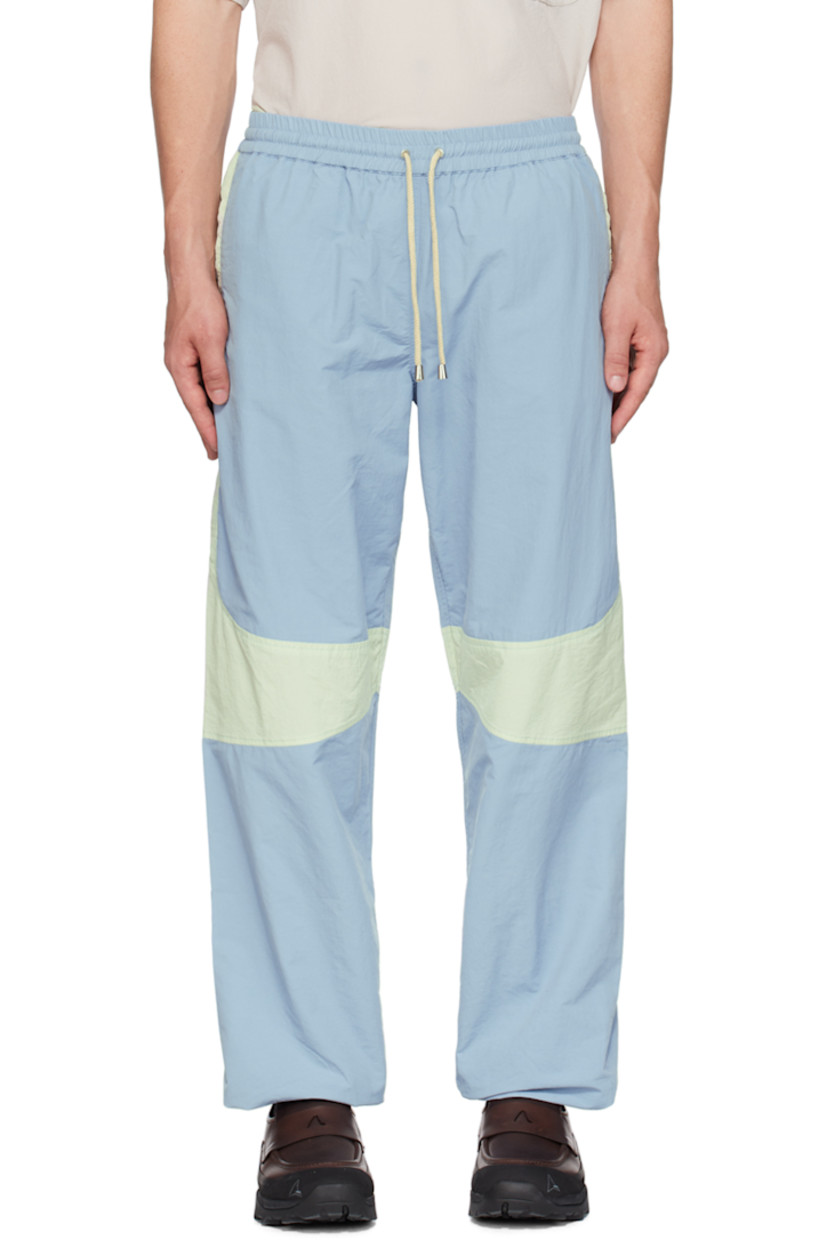 Nylon taffeta track pants.

· Paneled construction
· Drawstring at elasticized waistband
· Two-pocket styling
· Elasticized cuffs

Supplier color: Indigo