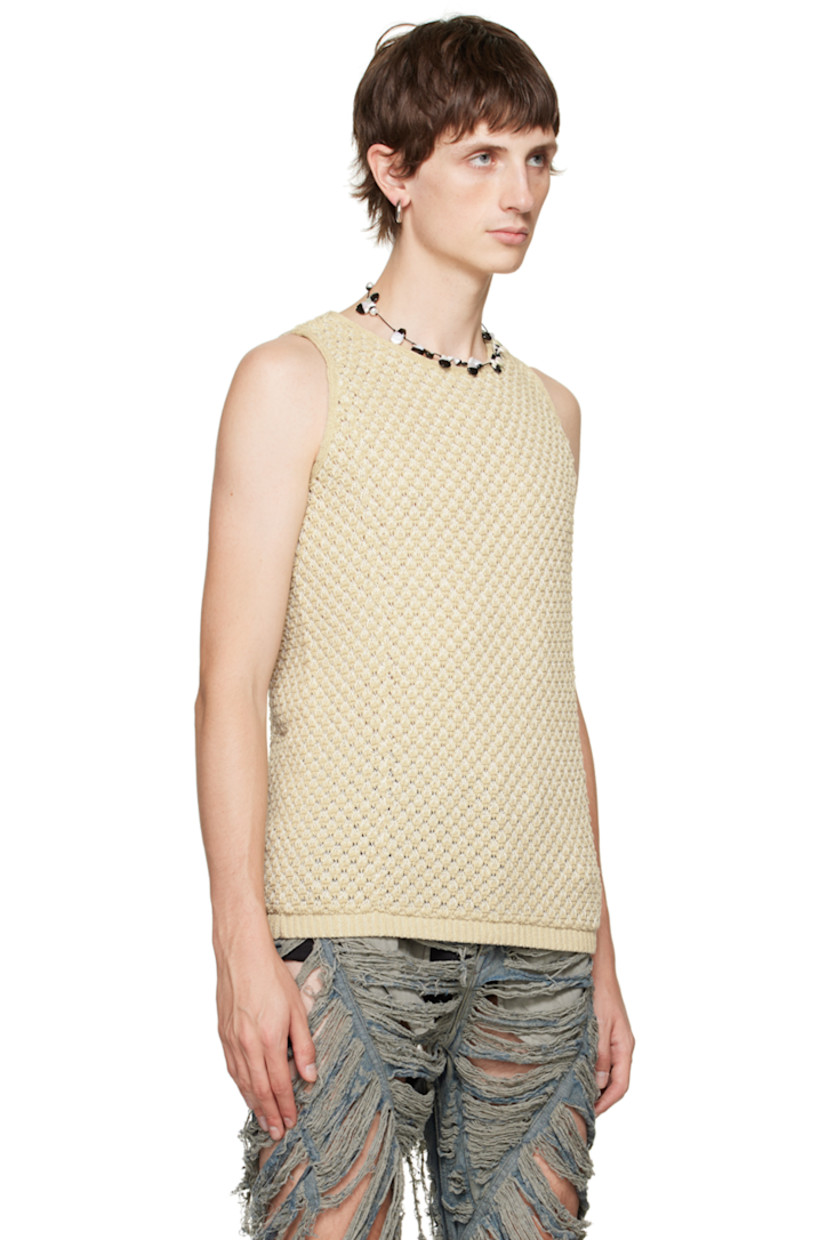 Handcrafted open knit stretch acrylic bouclé tank top. 

· Scoop neck
· Rib knit hem 
· Logo flag at back hem

Supplier color: Cereal