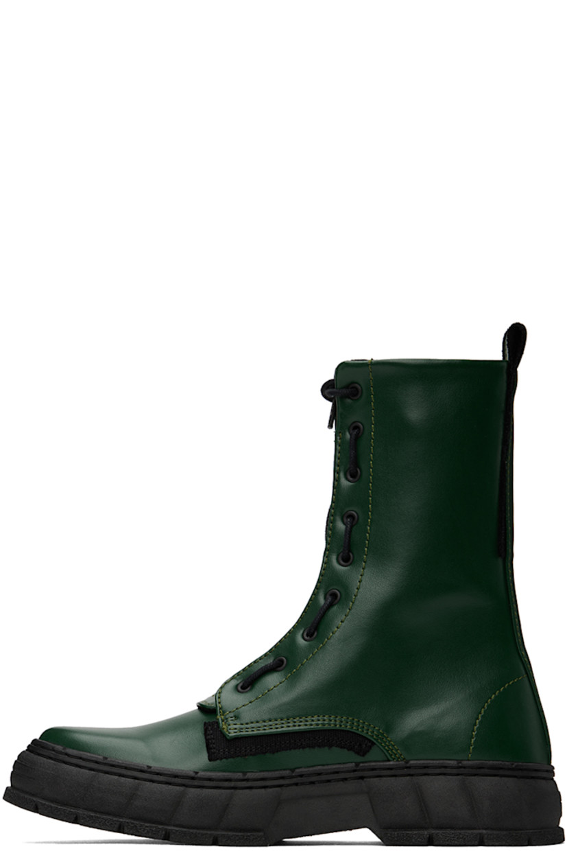 Handcrafted ankle-high PETA-certified buffed Appleskin™ faux-leather boots in green. Text printed at outer side.

· Lace-up and zip closure
· Logo printed at tongue
· Pull-loop at heel collar 
· Logo embossed at heel counter
· Grained faux-leather lining 
· Textured rubber midsole
· Treaded rubber outsole

Available exclusively at SSENSE.

Supplier color: Forest green