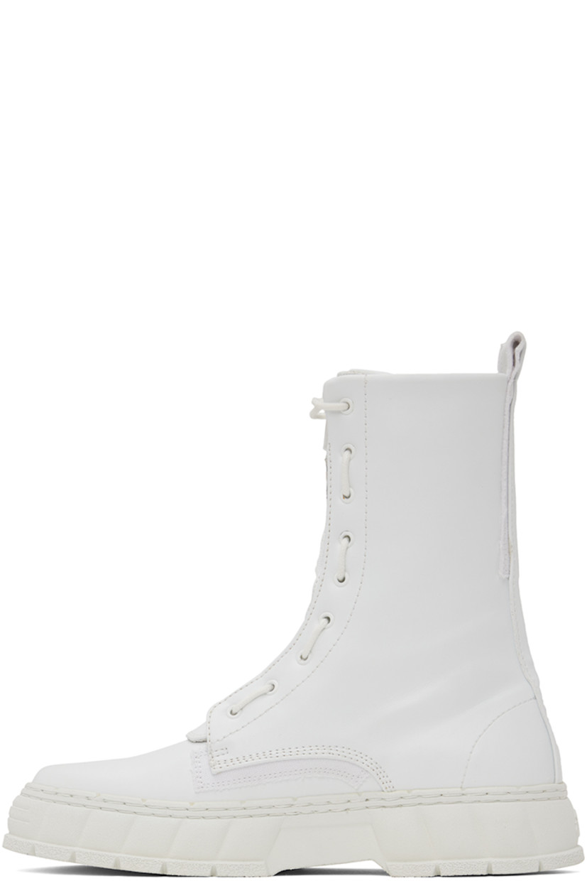Handcrafted ankle-high PETA-certified buffed Appleskin™ faux-leather boots in white. Text printed at outer side.

· Lace-up and zip closure
· Logo printed at tongue
· Pull-loop at heel collar
· Logo embossed at heel counter
· Twill lining
· Textured rubber midsole
· Treaded rubber outsole

Supplier color: White
