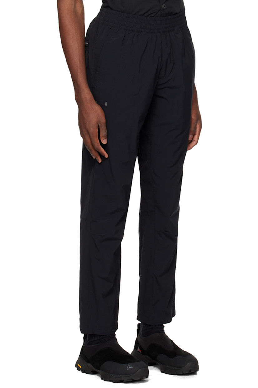Handcrafted straight-leg stretch regenerated nylon taffeta track pants. Wind-resistant and water-repellent.

· Concealed drawstring at elasticized waistband
· Three-pocket styling
· Mock-fly
· Logo patch at front
· Pleated knees
· Bungee-style drawstring at cuffs

Supplier color: Cosmic