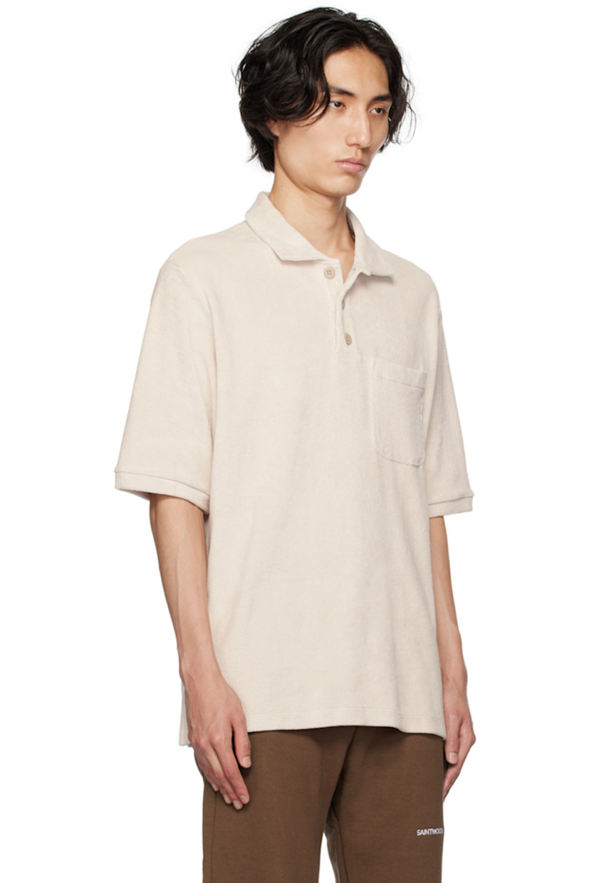 Cotton terrycloth polo.

· Spread collar
· Three-button placket
· Patch pocket
· Tennis-tail hem
· Logo flag at side seam
· Logo embroidered at back

Supplier color: Light grey