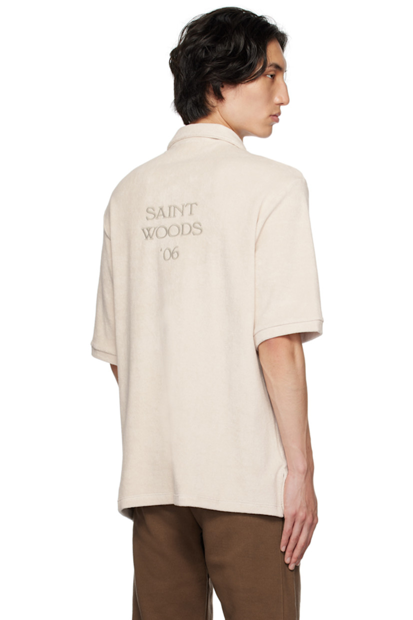 Cotton terrycloth polo.

· Spread collar
· Three-button placket
· Patch pocket
· Tennis-tail hem
· Logo flag at side seam
· Logo embroidered at back

Supplier color: Light grey