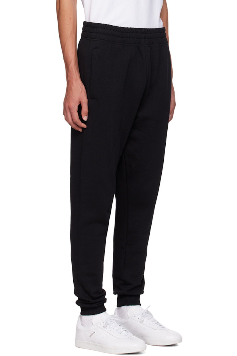 Relaxed-fit 340 g organic cotton fleece sweatpants.

· Concealed drawstring at elasticized waistband
· Two-pocket styling
· Logo patch at front
· Rib knit cuffs

Supplier color: Black