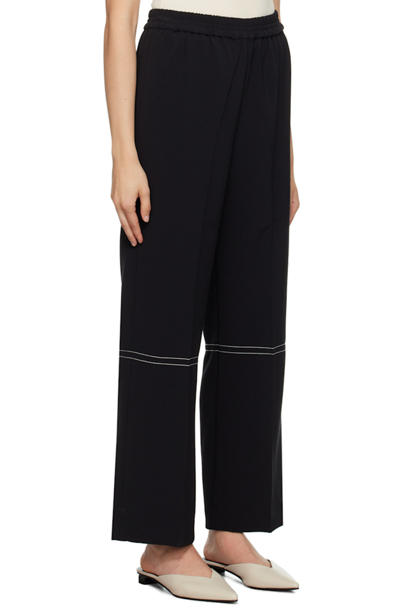 Wide-leg stretch polyester-blend crepe trousers. 

· Elasticized waistband
· Creased legs
· Contrast stitching in white

Supplier color: Black