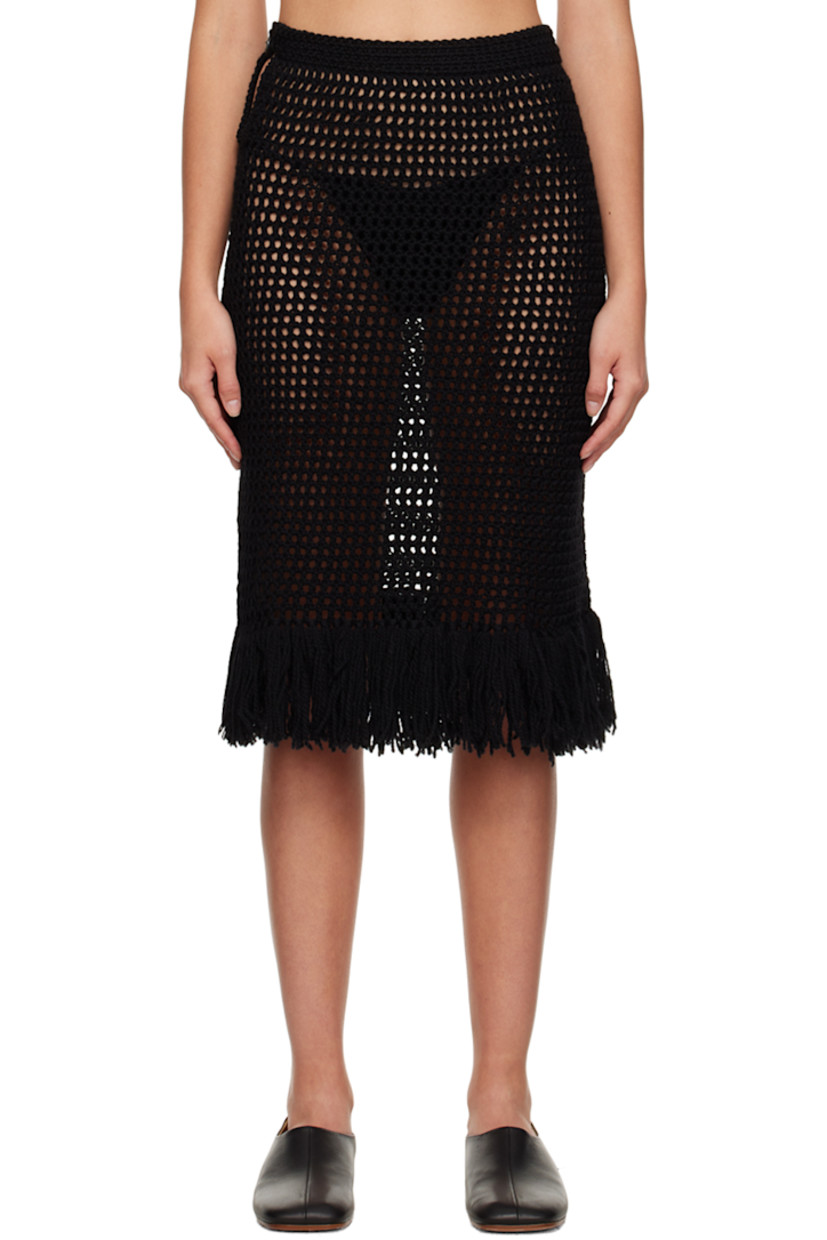 Hand-crafted semi-sheer open-knit merino wool skirt.

· Single-button closure at waistband
· Fringed detailing at hem

Supplier color: Black