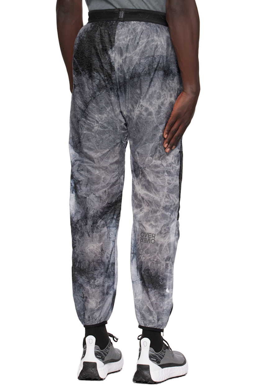 Nylon taffeta track pants. Graphic pattern throughout.

· Paneled construction
· Drawstring at elasticized waistband
· Two-pocket styling
· Logo print at front
· Elasticized cuffs
· Zip vent at outseams 
· Logo flag at back waistband
· Partial mesh lining

Supplier color: Acid rain