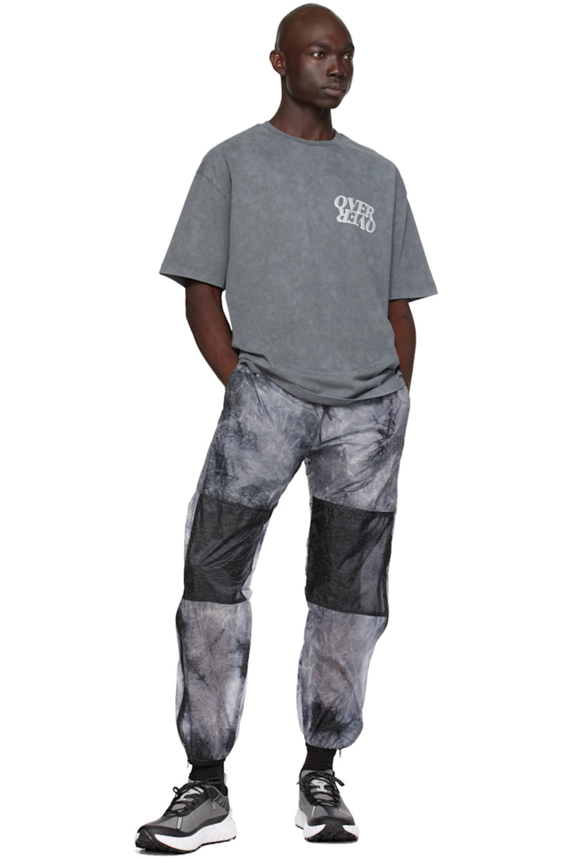 Nylon taffeta track pants. Graphic pattern throughout.

· Paneled construction
· Drawstring at elasticized waistband
· Two-pocket styling
· Logo print at front
· Elasticized cuffs
· Zip vent at outseams 
· Logo flag at back waistband
· Partial mesh lining

Supplier color: Acid rain