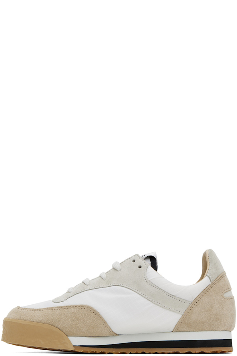 Low-top paneled suede, nappa calfskin, and mesh sneakers in white and beige.

· Crepe rubber trim at toe
· Lace-up closure
· Textile logo patch at padded tongue
· Padded collar
· Buffed calfskin and mesh lining
· Foam rubber midsole
· Treaded rubber outsole

Supplier color: Ivory