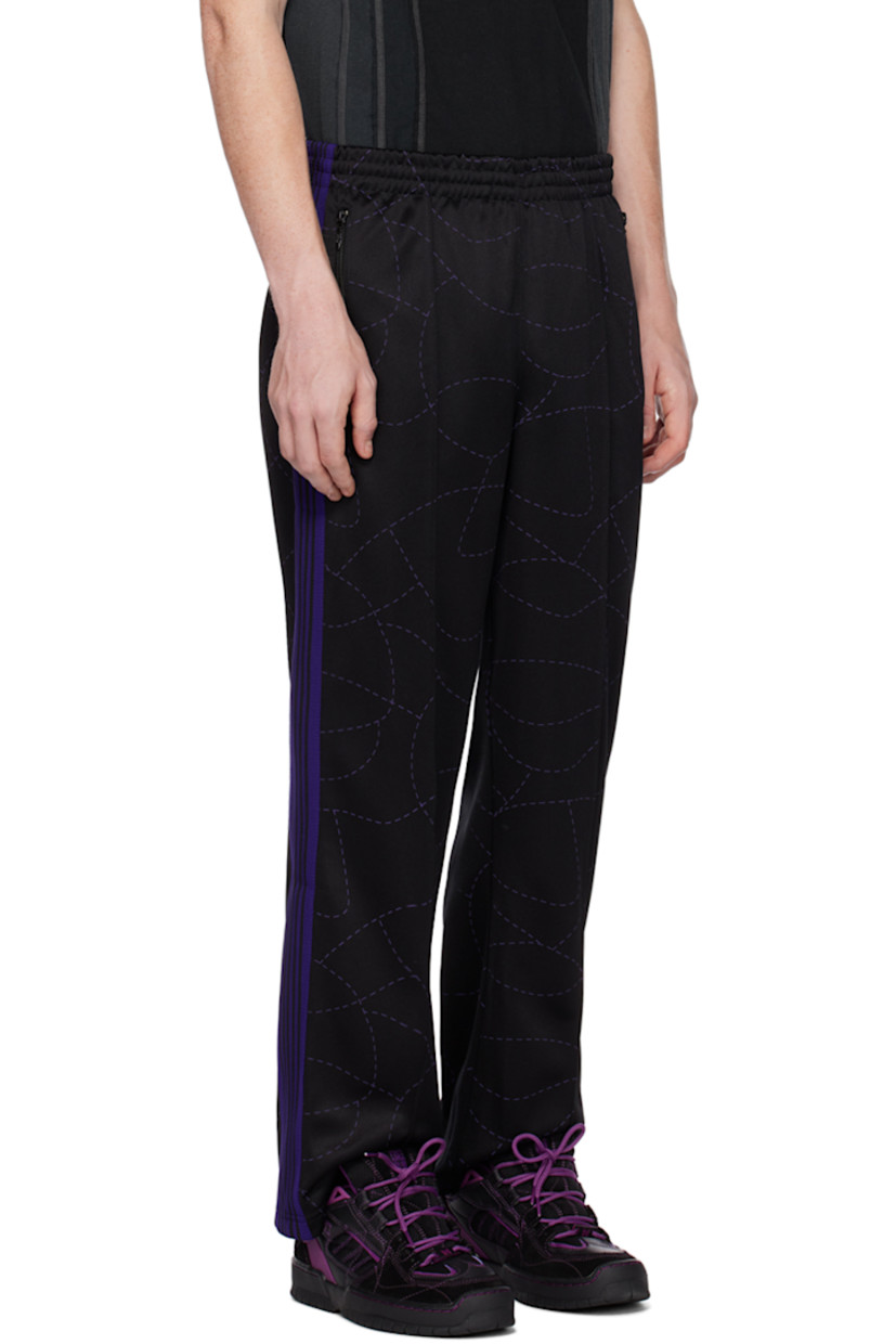 Polyester jersey track pants. Graphic pattern printed throughout.

· Concealed drawstring at elasticized waistband
· Three-pocket styling
· Pinched seams at front legs
· Logo embroidered at front
· Striped knit trim at outseams

Part of the Needles x DC Shoes collaboration.

Supplier color: Black