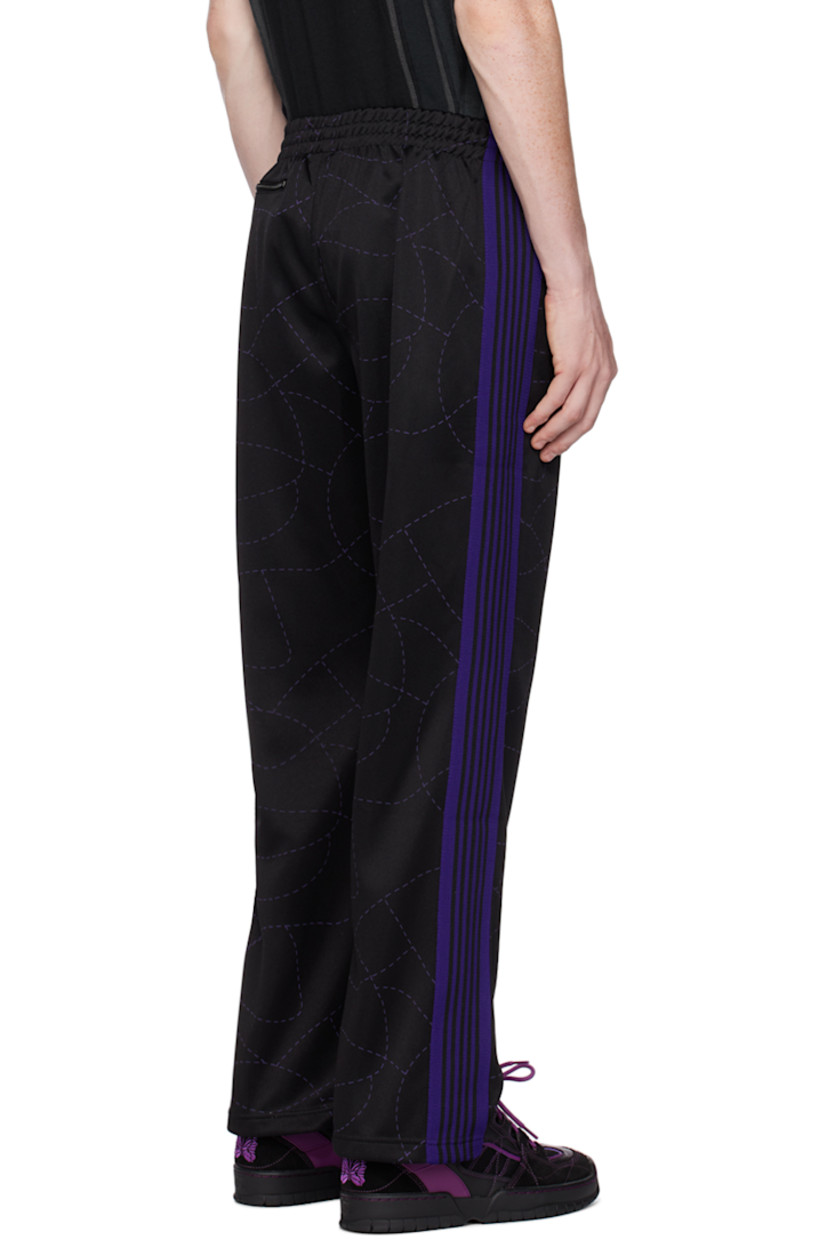 Polyester jersey track pants. Graphic pattern printed throughout.

· Concealed drawstring at elasticized waistband
· Three-pocket styling
· Pinched seams at front legs
· Logo embroidered at front
· Striped knit trim at outseams

Part of the Needles x DC Shoes collaboration.

Supplier color: Black