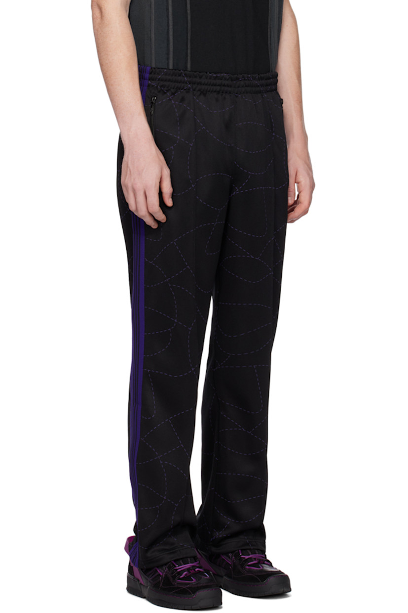 Polyester jersey track pants. Graphic pattern printed throughout.

· Concealed drawstring at elasticized waistband
· Three-pocket styling
· Pinched seams at front legs
· Logo embroidered at front
· Striped knit trim at outseams

Part of the Needles x DC Shoes collaboration.

Supplier color: Black