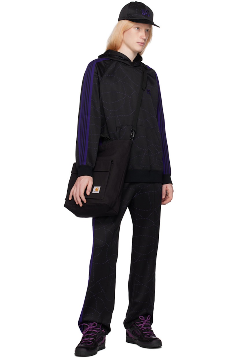 Polyester jersey track pants. Graphic pattern printed throughout.

· Concealed drawstring at elasticized waistband
· Three-pocket styling
· Pinched seams at front legs
· Logo embroidered at front
· Striped knit trim at outseams

Part of the Needles x DC Shoes collaboration.

Supplier color: Black