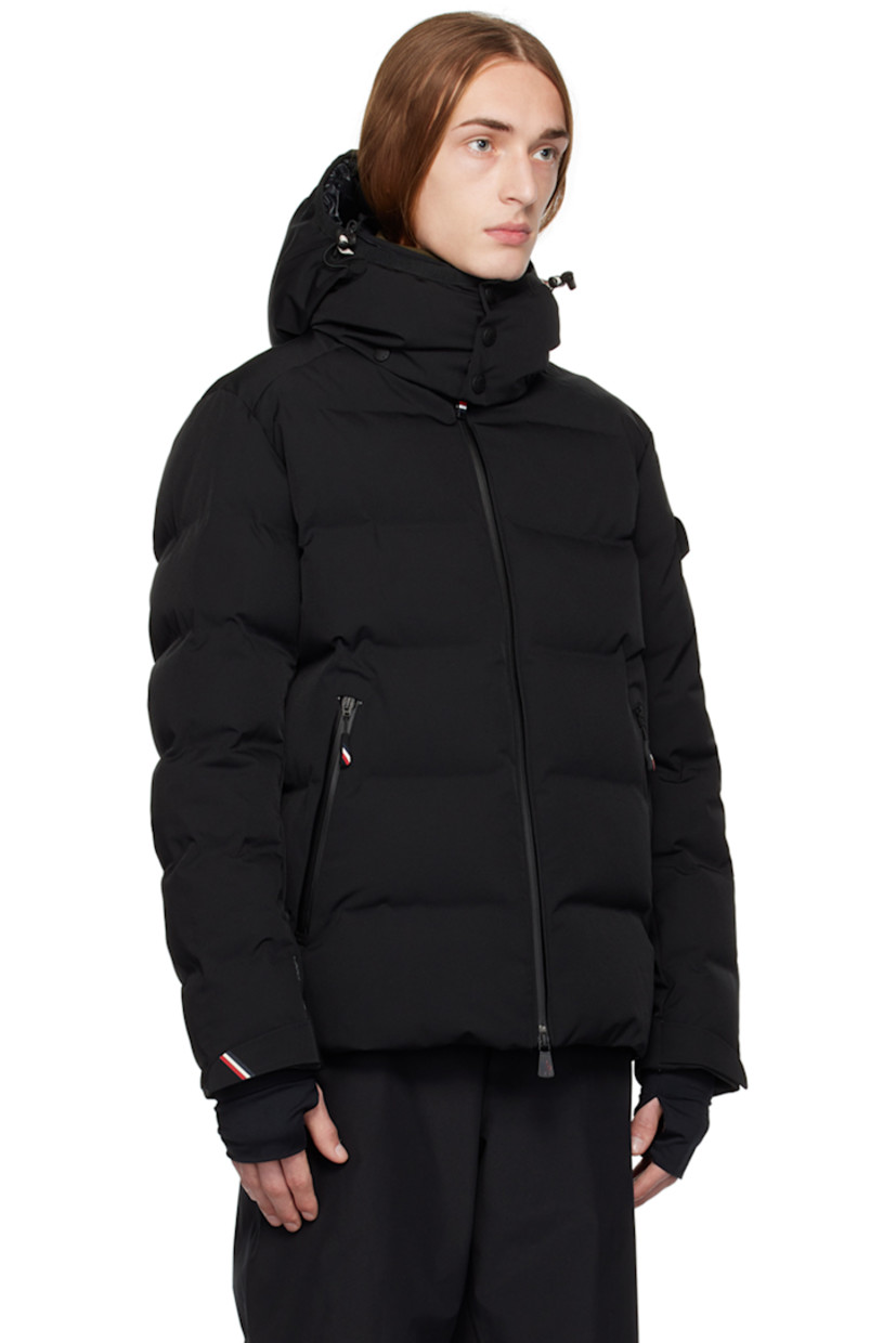 Down-filled quilted 2L stretch nylon twill jacket. Water-repellent, windproof, lightweight, and breathable.

· Detachable hood
· Bungee-style drawstring and press-stud fastening at hood
· Stand collar
· Two-way zip closure 
· Zip pockets
· Bungee-style drawstring at hem
· Embroidered logo patch and flap pocket at sleeve
· Velcro strap at cuffs
· Thumbhole at inset jersey cuffs
· Zip pocket and powder skirt at interior
· Nylon satin lining
· YKK® Aquaguard® hardware

Supplier color: Black

Fill: 90% goose down, 10% feathers.