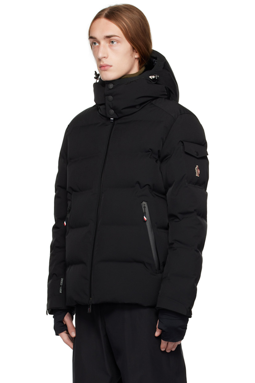 Down-filled quilted 2L stretch nylon twill jacket. Water-repellent, windproof, lightweight, and breathable.

· Detachable hood
· Bungee-style drawstring and press-stud fastening at hood
· Stand collar
· Two-way zip closure 
· Zip pockets
· Bungee-style drawstring at hem
· Embroidered logo patch and flap pocket at sleeve
· Velcro strap at cuffs
· Thumbhole at inset jersey cuffs
· Zip pocket and powder skirt at interior
· Nylon satin lining
· YKK® Aquaguard® hardware

Supplier color: Black

Fill: 90% goose down, 10% feathers.