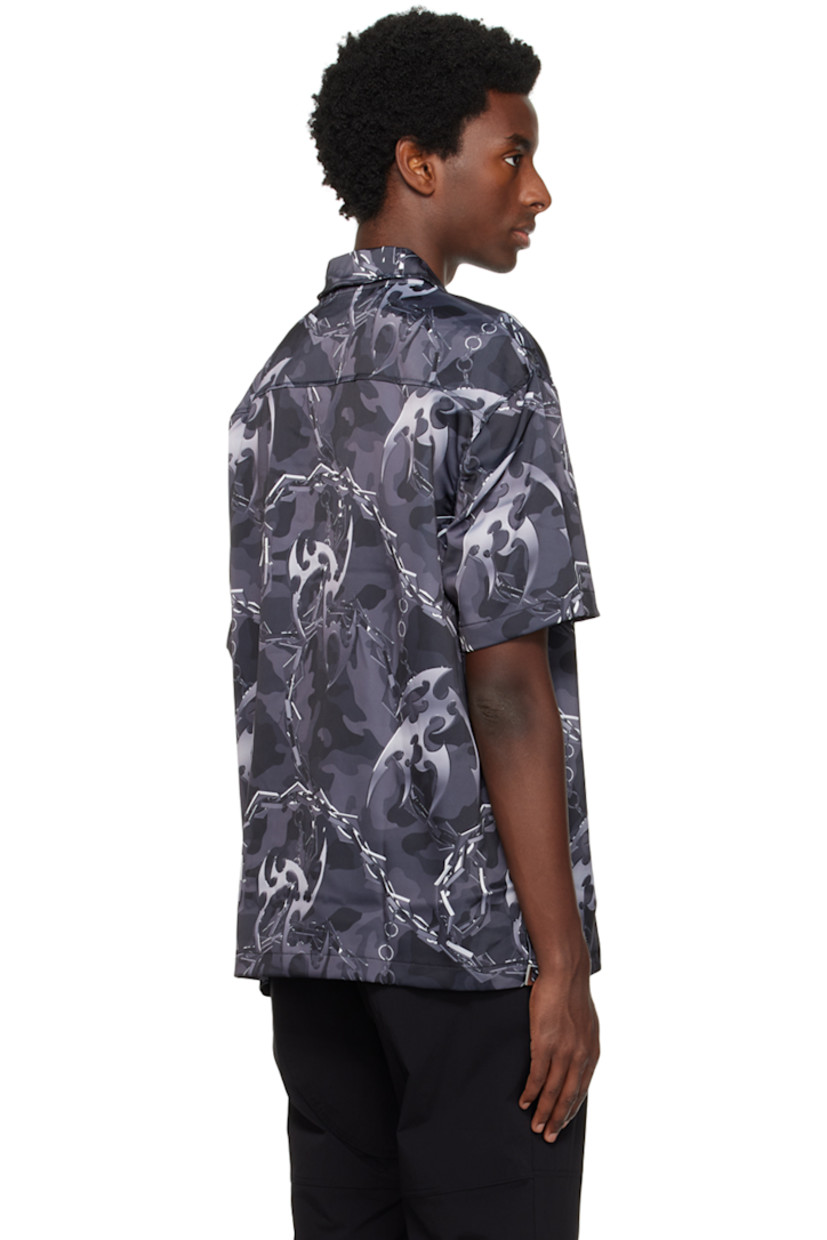 Crinkled polyester satin shirt. Graphic pattern printed throughout. 

· Spread collar
· Button closure
· Patch pocket at chest
· Graphic hardware at vented side seams

Supplier color: Camo