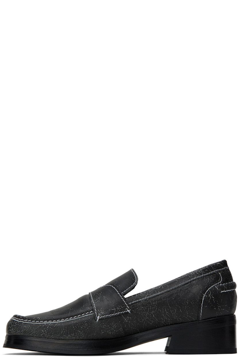 Cracked grained leather loafers in black. 

· Square moc toe
· Logo embossed at leather footbed
· Buffed leather lining
· Rubber sole
· Heel: H1.25 in
· Contrasting stitching in white

Supplier color: Black