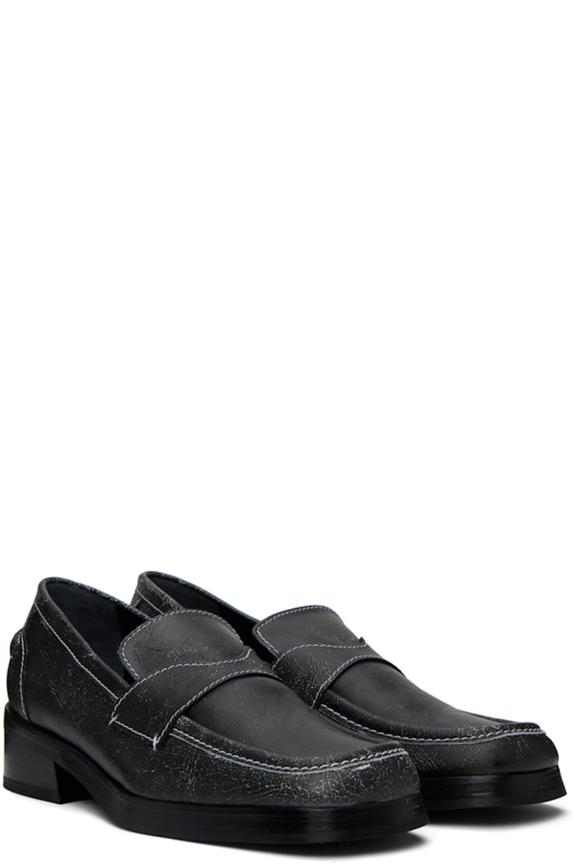 Cracked grained leather loafers in black. 

· Square moc toe
· Logo embossed at leather footbed
· Buffed leather lining
· Rubber sole
· Heel: H1.25 in
· Contrasting stitching in white

Supplier color: Black