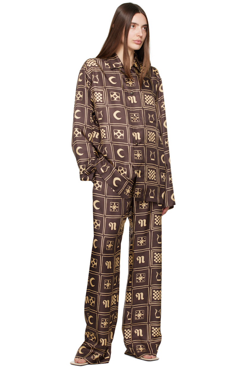 Straight-leg silk satin trousers. Graphic pattern printed throughout.

· Belt loops
· Self-tie belt at elasticized waistband
· Two-pocket styling

Supplier color: Apricot totem inverse brown