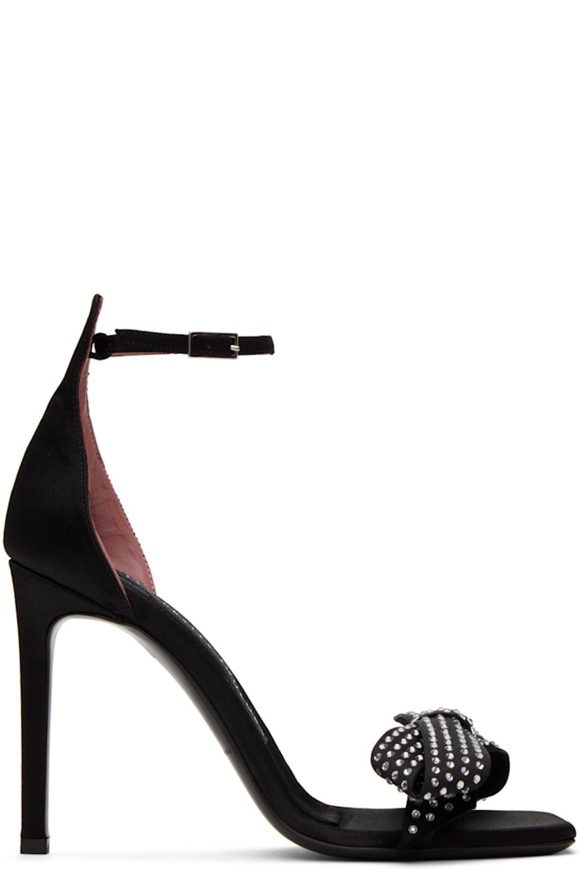 Satin heeled sandals in black. 

· Open square toe 
· Crystal-cut bow appliqué at vamp 
· Pin-buckle ankle strap
· Logo patch at footbed 
· Covered stiletto heel with rubber injection
· Leather sole 
· Heel: H4 in

Supplier color: Satin black strass crystal