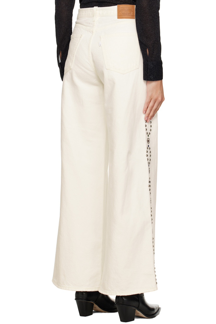 Wide-leg non-stretch denim jeans. Subtle distressing throughout. 

· Belt loops 
· Five-pocket styling 
· Zip-fly 
· Beaded detailing and studs at outseams 
· Leather logo patch at back waistband 
· Logo flag at back pocket 

Supplier color: White