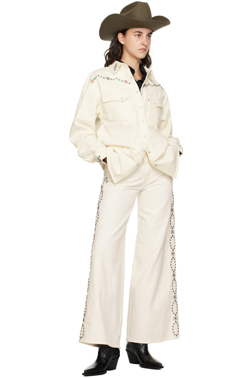Wide-leg non-stretch denim jeans. Subtle distressing throughout. 

· Belt loops 
· Five-pocket styling 
· Zip-fly 
· Beaded detailing and studs at outseams 
· Leather logo patch at back waistband 
· Logo flag at back pocket 

Supplier color: White