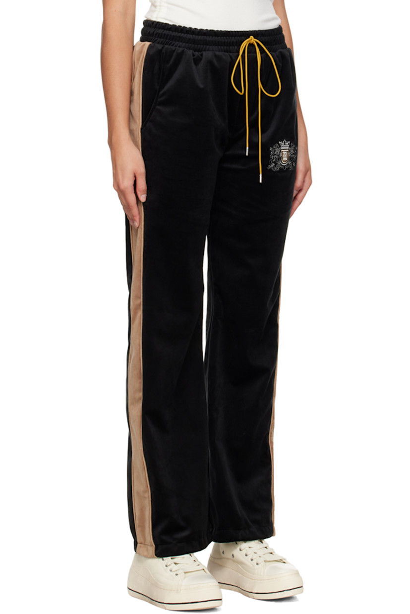 Polyester velour lounge pants.

· Drawstring at elasticized waistband
· Four-pocket styling
· Mock-fly 
· Logo graphic embroidered at leg
· Striped trim at outseams

Supplier color: Black/Khaki